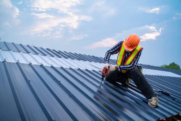roofing contractors colorado springs man drilling roof