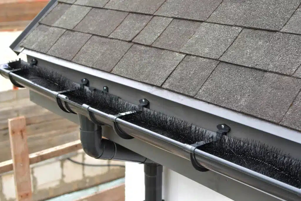 Gutter guard types - brush gutter guards installed on asphalt shingle roof