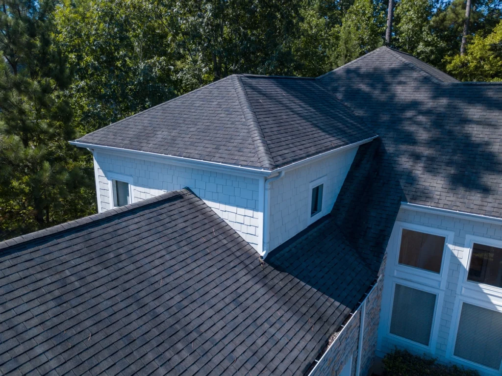 Aerial view of asphalt roof top to be inspected after storm damage
