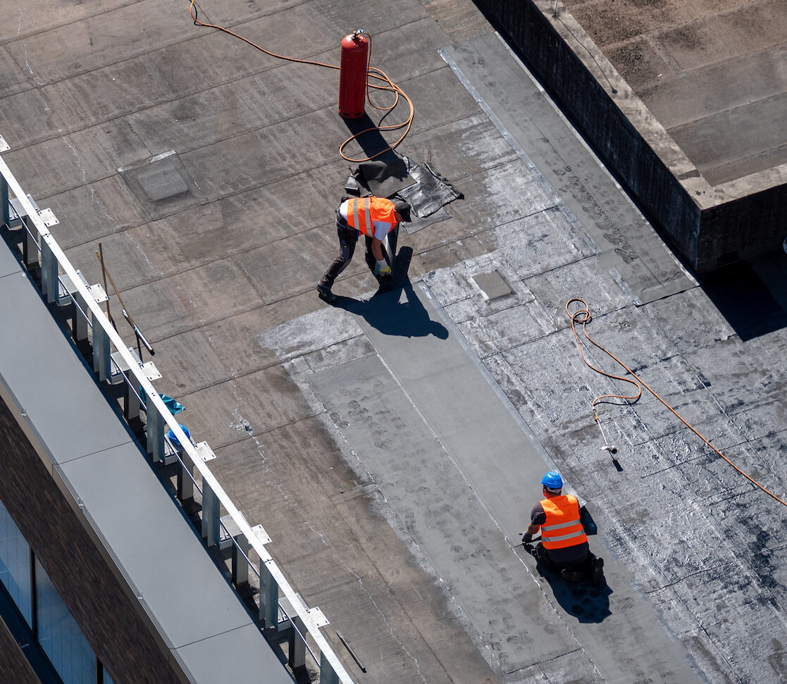 commercial roof repair team on flat roof