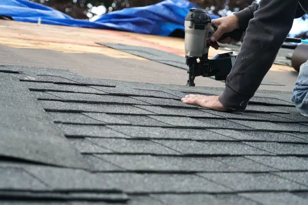 roofing contractor installing roof shingles