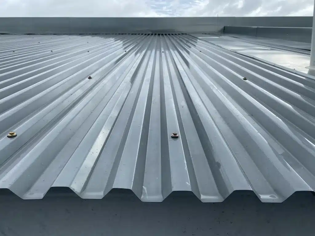 Close up of grey corrugated commercial metal roofing - new installation