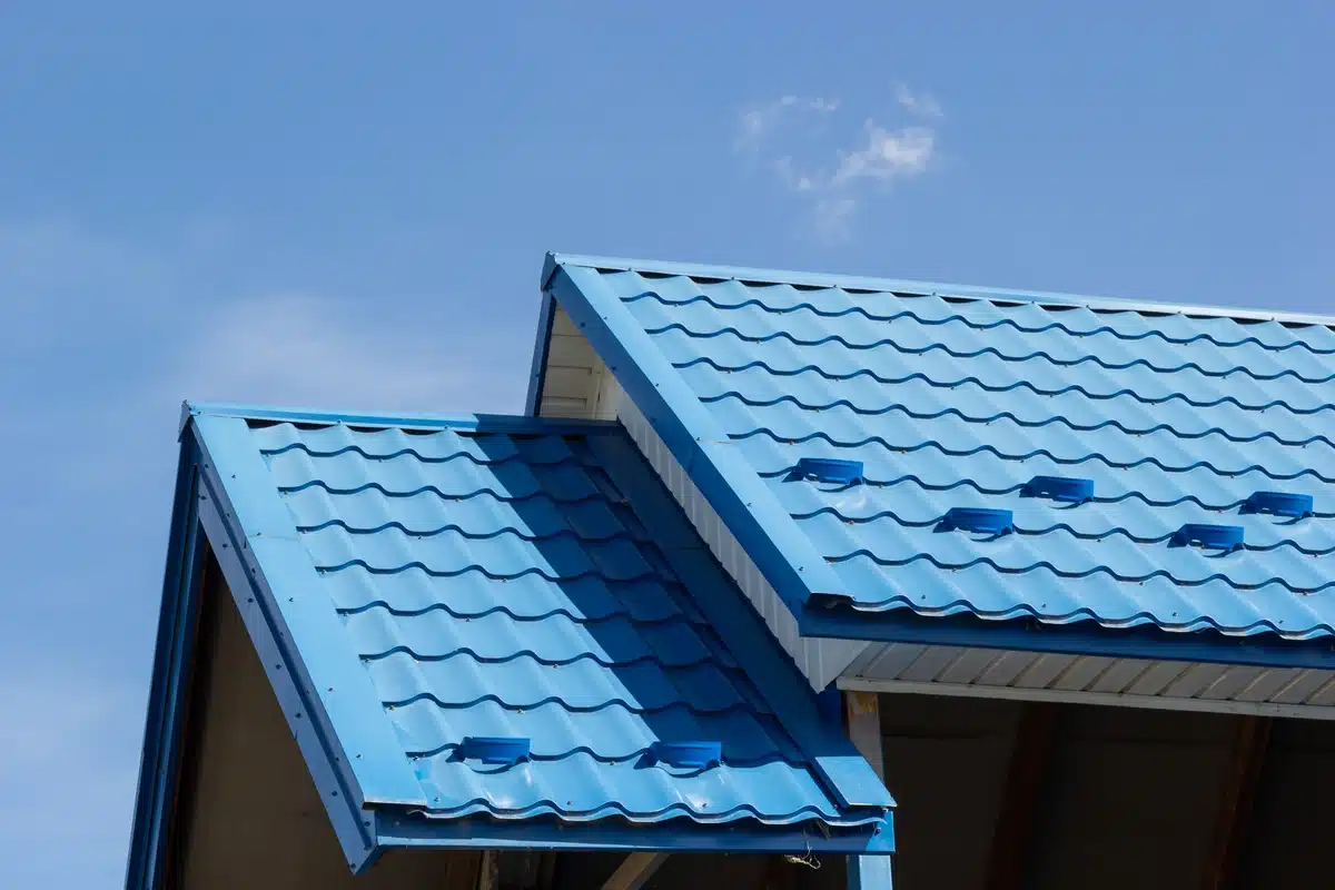 residential house roof covered with metal blue tiles
