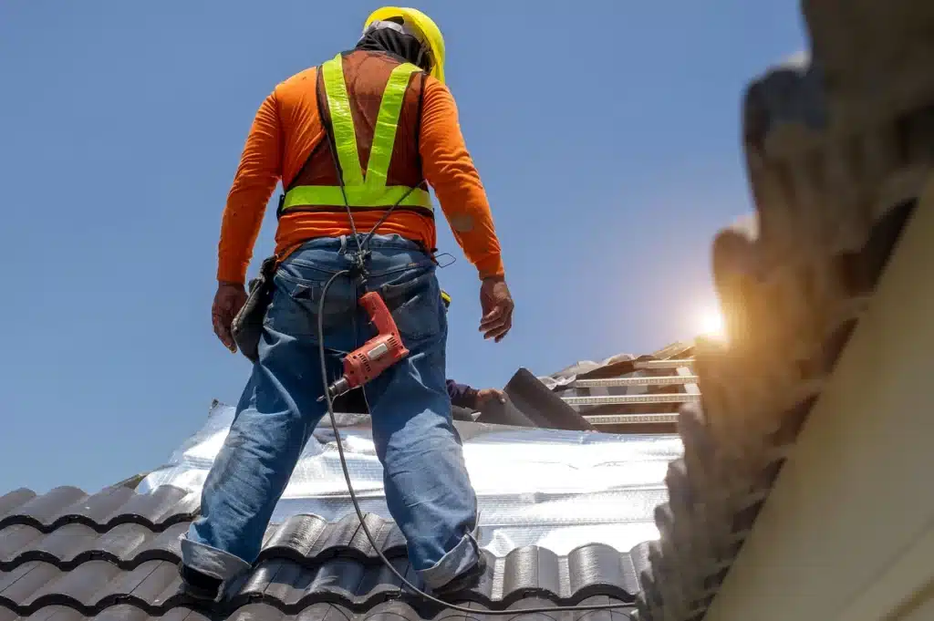 man wearing harness standing on the roof for repair