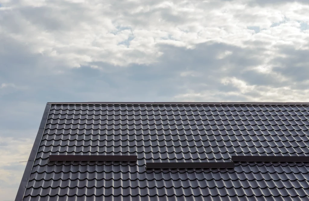 tile house roof slope against cloudy sky