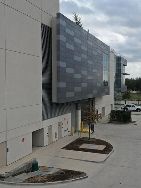 Gray patterned architectural composite panels on a commercial building facade